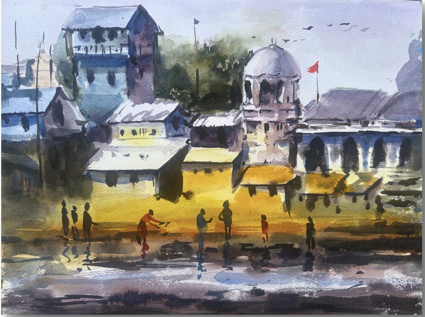 Ghat buildings at sunset with figures